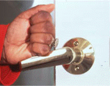 A man's hand using a doorknob.