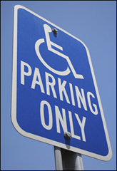 Accessible Parking Sign. Blue Background, White International Symbol of Accessibility, and the word Parking in white under the symbol.